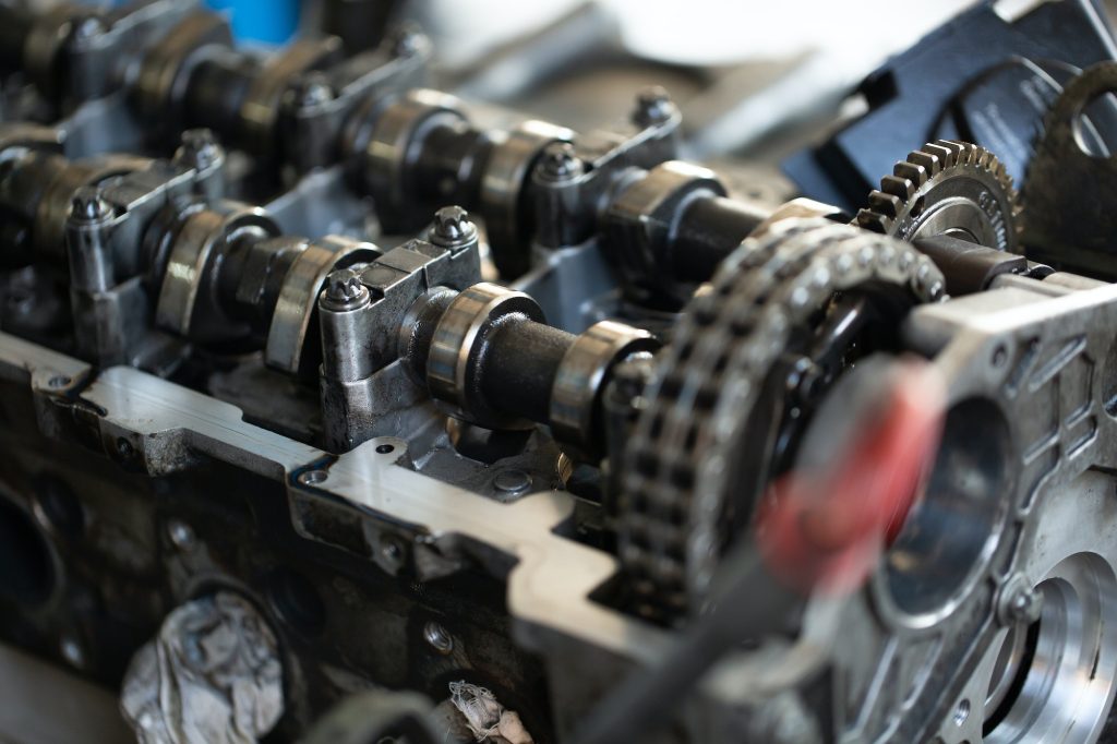 Master, car mechanic repairs the car engine at the service station